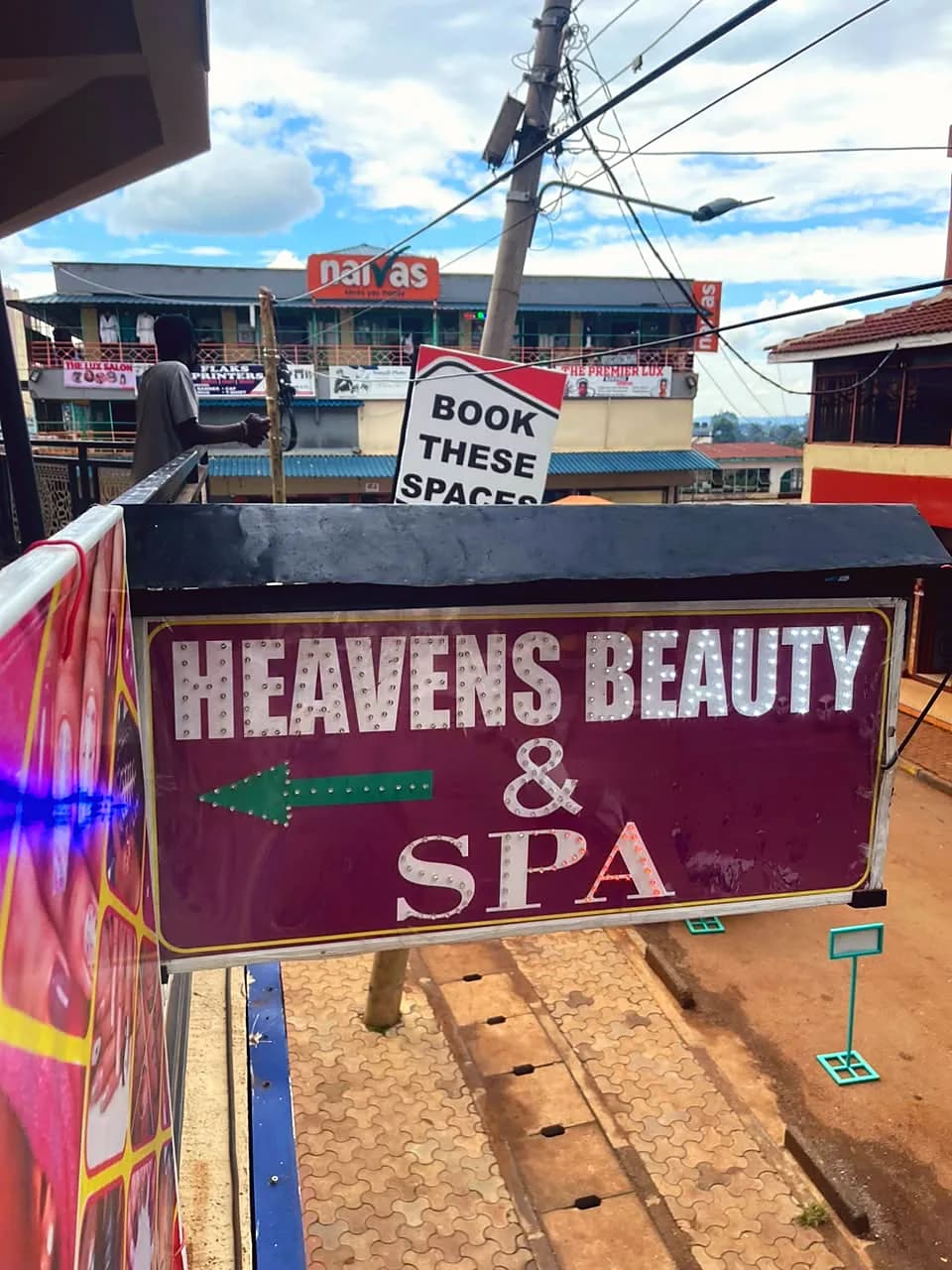 Lit Heavens Beauty & Spa street sign with an arrow pointing to the salon in Kapsabet town